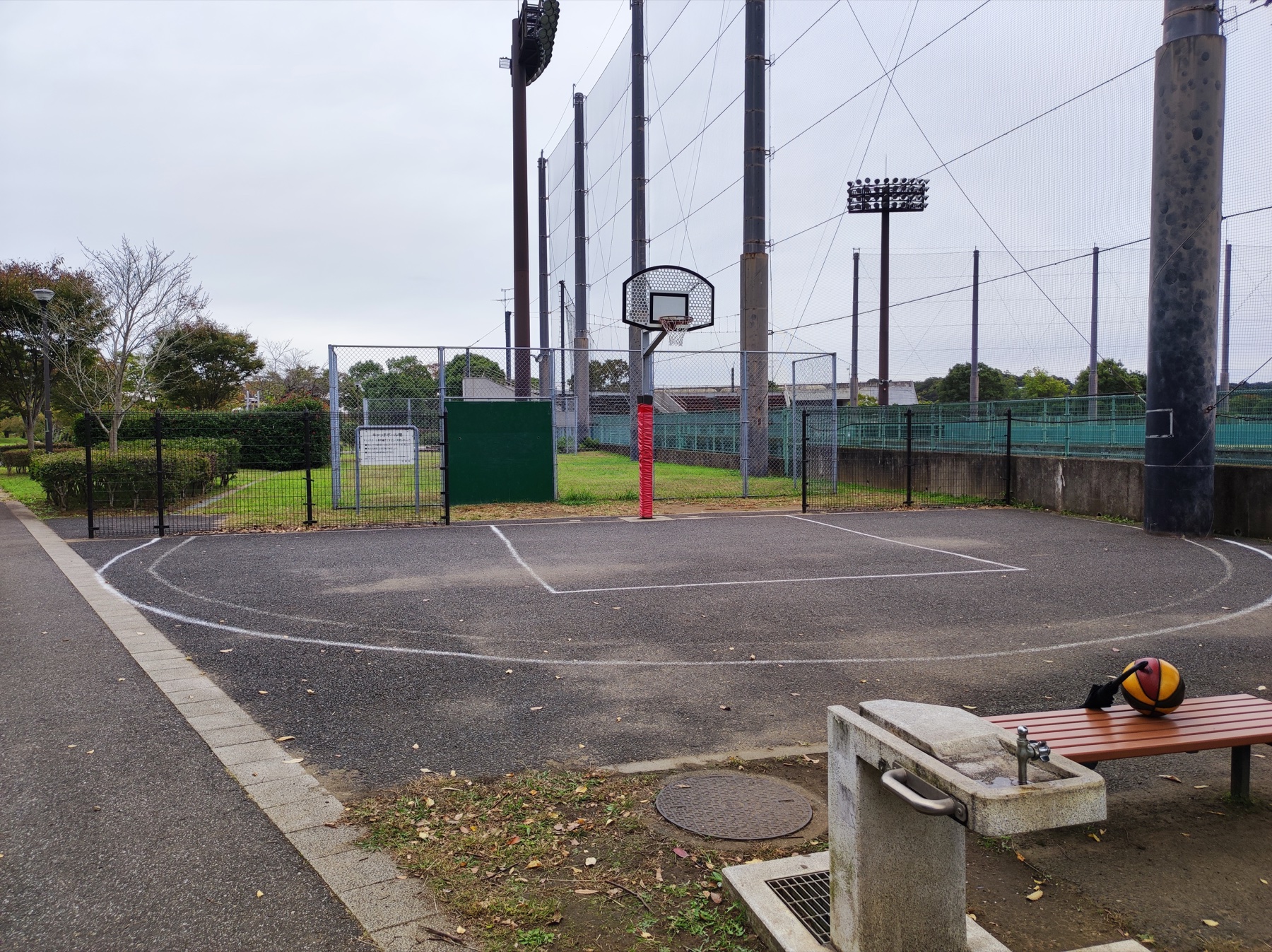 松山下公園のバスケットコート脇にある水飲み場とベンチ